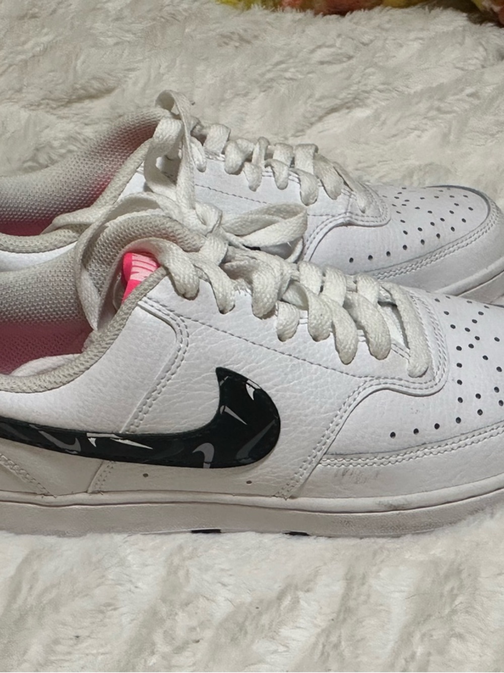 Nike White Low-Top Sneakers with Black Patterned Swoosh and Pink Tongue Accent